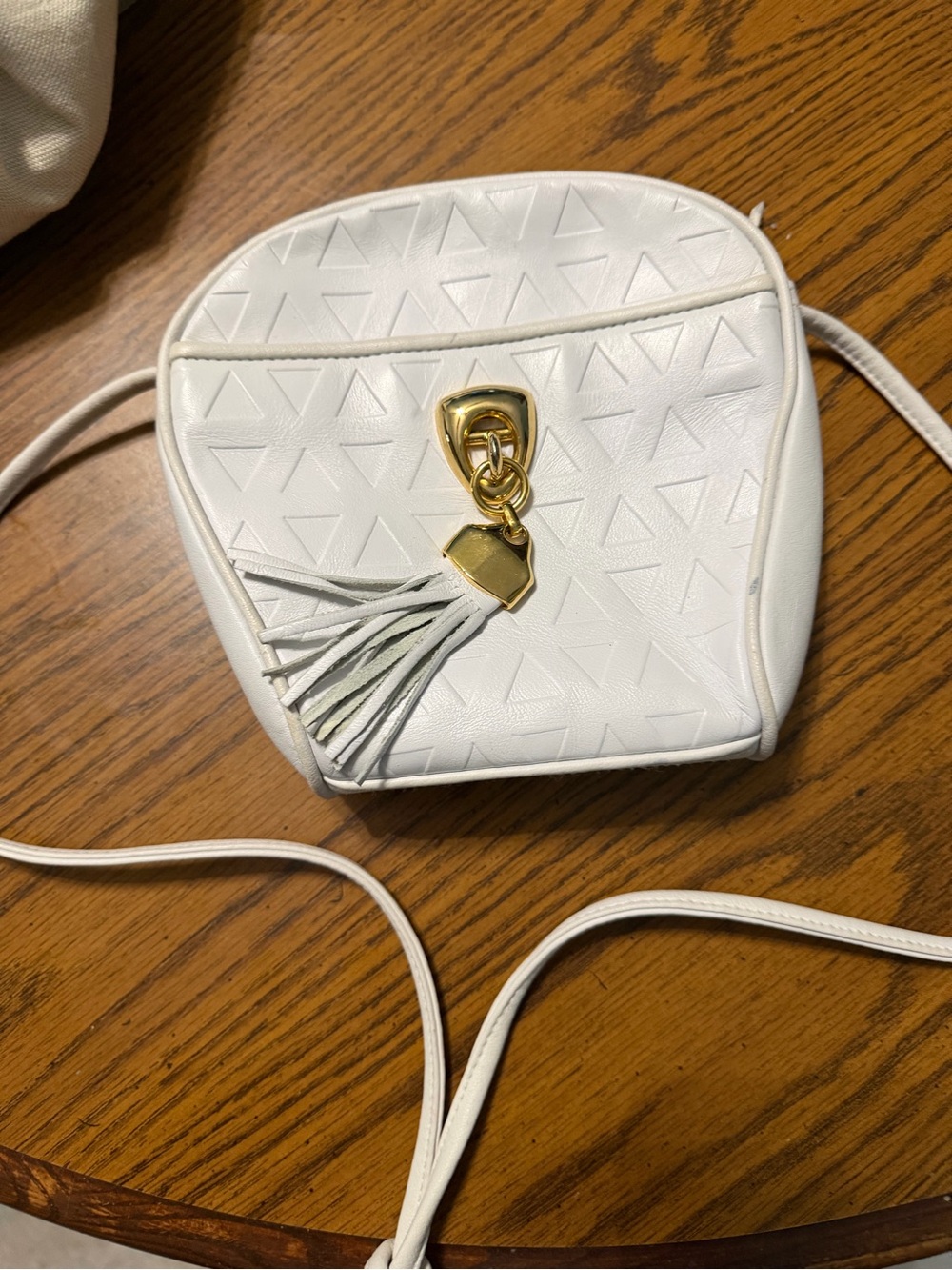 White Crossbody Bag with Gold Tassel Accent